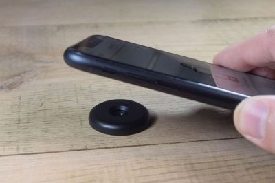 iphone held close to an industrial nfc disc tag