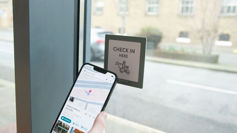 Phone scanning NFC Checkpoint in coffee shop