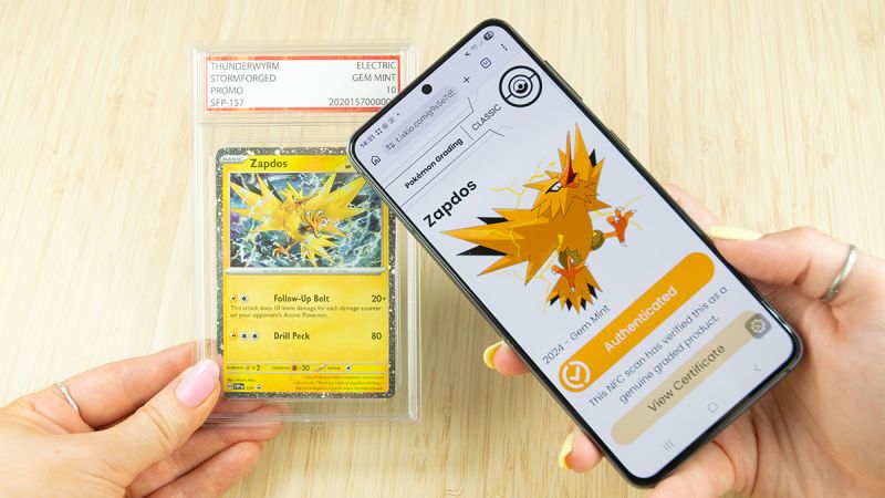 Phone showing NFC authentication on a genuine trading card in slab