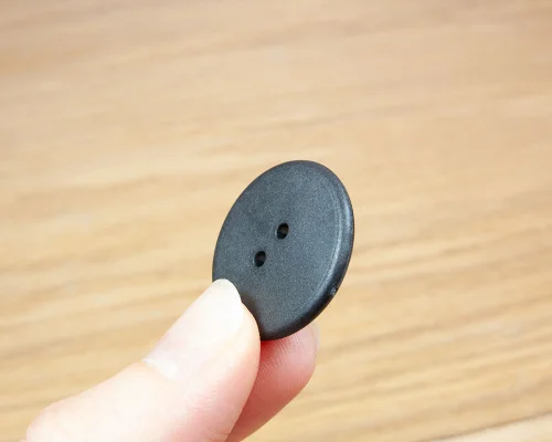 Close up image of an NFC 25.5mm Button Laundry Tag NTAG213