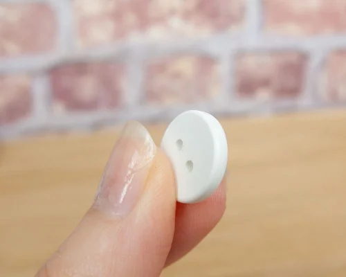 Close up image of an NFC Custom Print 15mm Button Laundry Tag