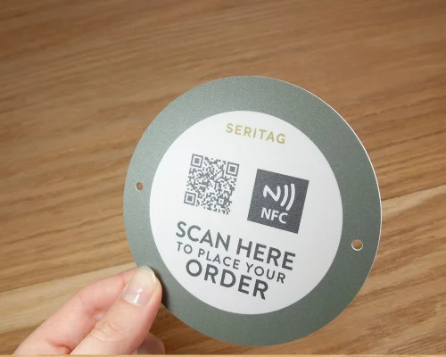 Close up image of an NFC Outdoor Table Ordering Tag